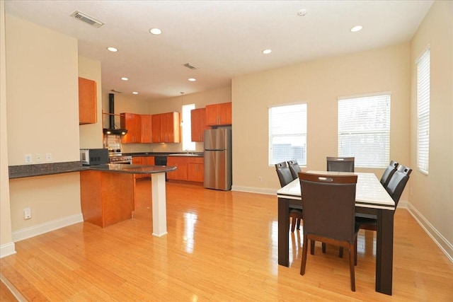 dining space with light hardwood / wood-style flooring