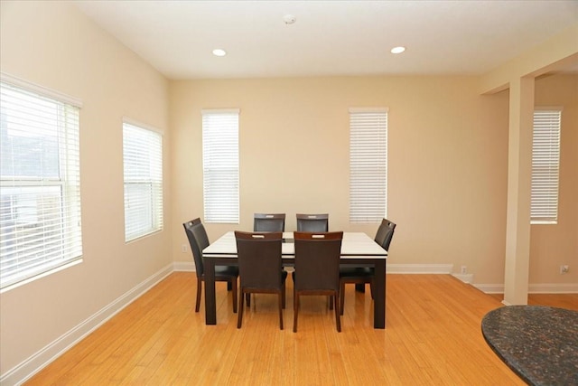 dining space with light hardwood / wood-style floors