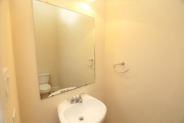 bathroom featuring sink and toilet