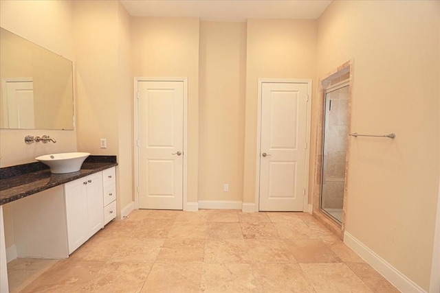 bathroom featuring vanity and a shower with shower door