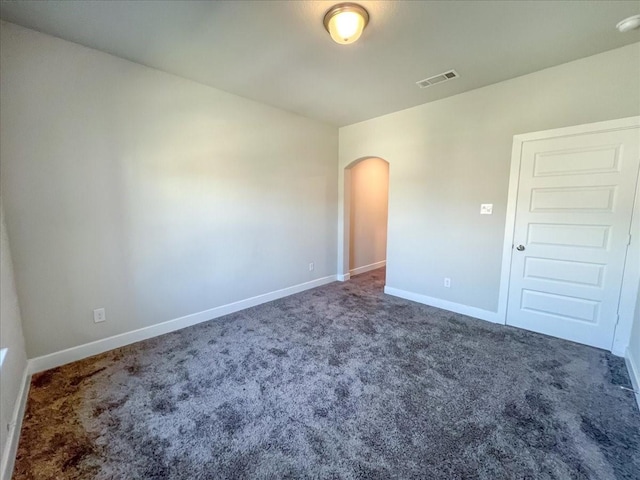 empty room with dark carpet