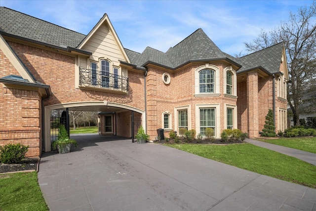 view of front of house featuring a carport and a balcony