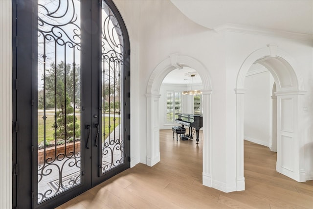 entryway featuring a chandelier and light hardwood / wood-style flooring