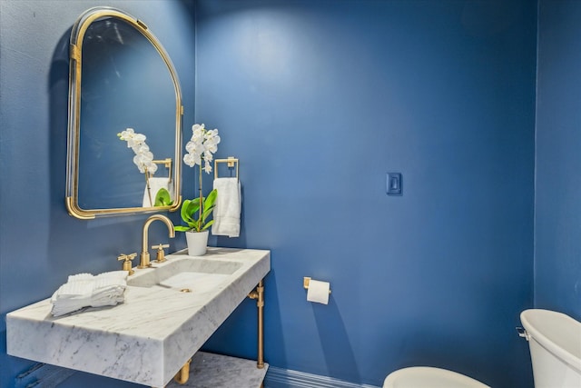 bathroom featuring sink and toilet