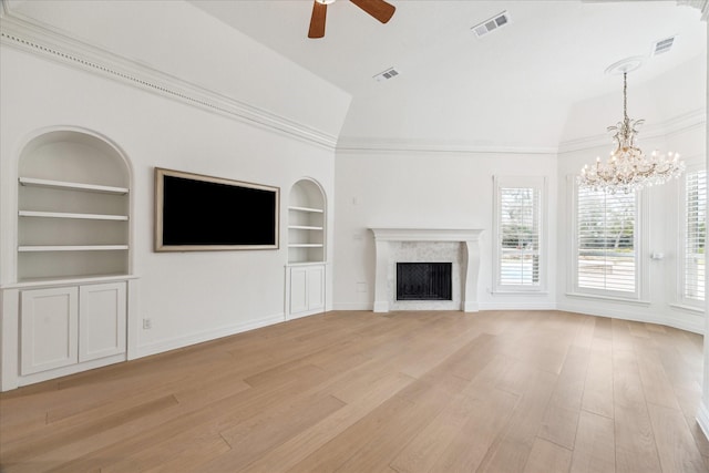 unfurnished living room featuring light hardwood / wood-style flooring, built in shelves, vaulted ceiling, and a high end fireplace