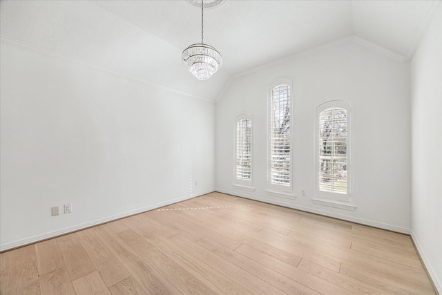 spare room featuring an inviting chandelier, lofted ceiling, and light hardwood / wood-style flooring