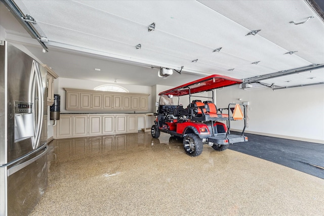 garage featuring a garage door opener and stainless steel fridge