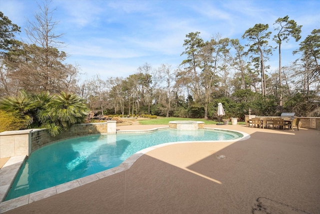 view of pool with a patio and an in ground hot tub