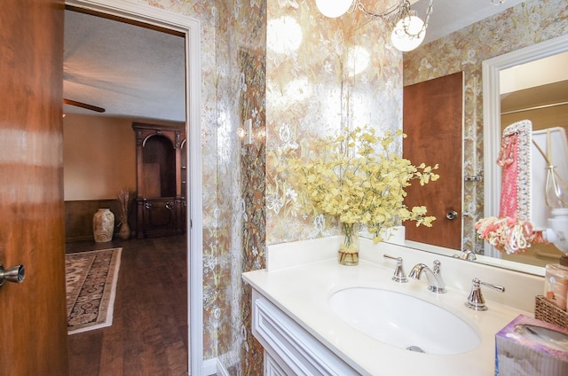 11943 Fawnview Dr, Houston, TX 77070 - bathroom with vanity, wood finished floors, and wallpapered walls