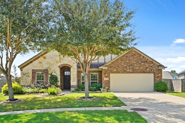 view of front of property featuring a garage and a front yard