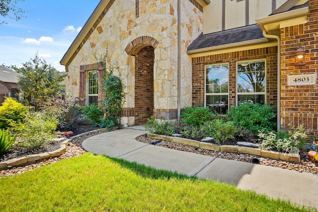 doorway to property with a yard