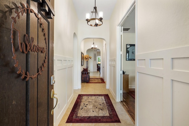 interior space with an inviting chandelier and light tile patterned floors