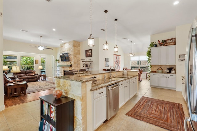 kitchen featuring sink, an island with sink, white cabinets, and appliances with stainless steel finishes