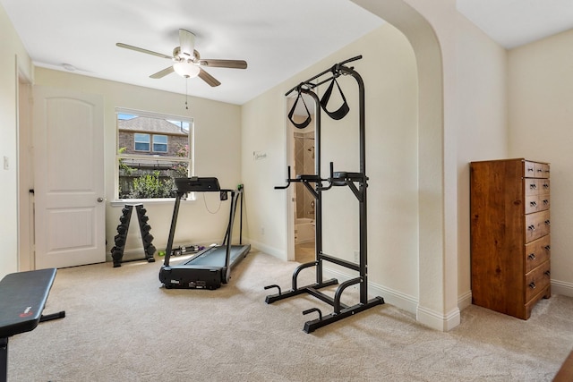 exercise area featuring light carpet and ceiling fan