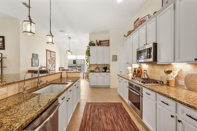 kitchen with appliances with stainless steel finishes, decorative light fixtures, sink, and white cabinets