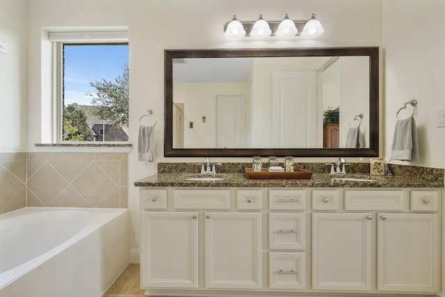 bathroom with vanity, a tub to relax in, and tile patterned floors