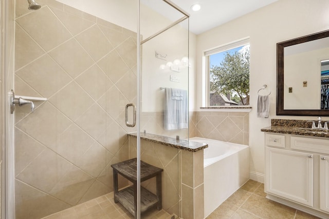 bathroom featuring vanity, tile patterned floors, and shower with separate bathtub