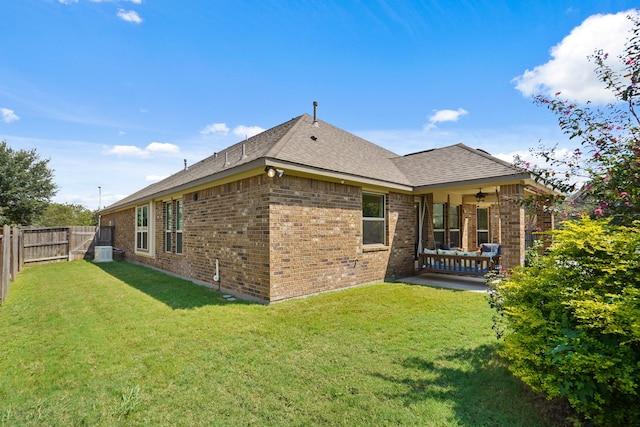 rear view of property with a lawn and a patio area