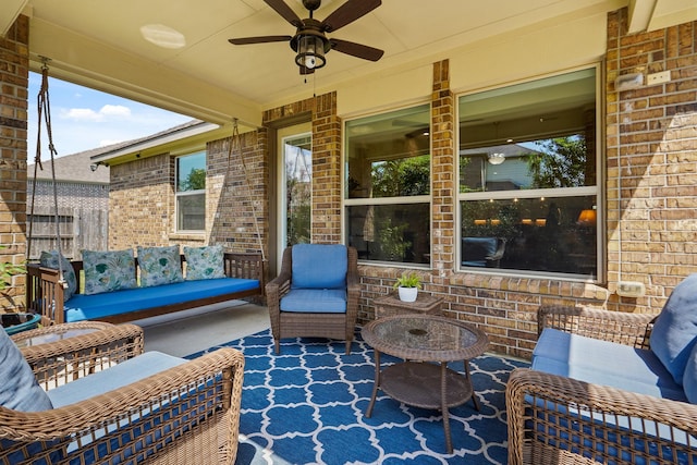 view of patio with an outdoor living space and ceiling fan