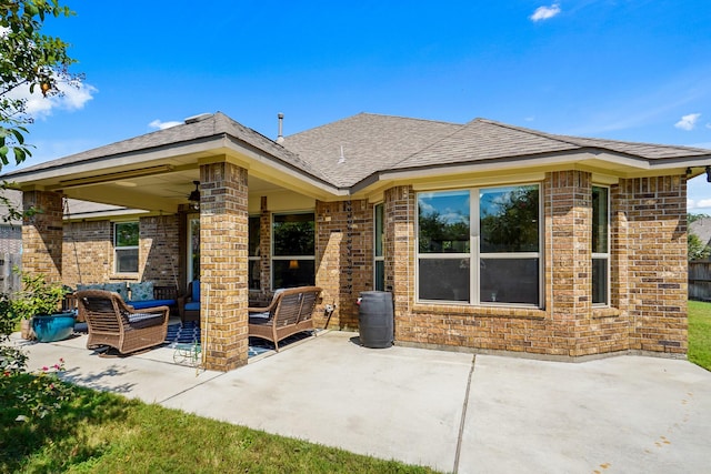 rear view of property featuring an outdoor living space, ceiling fan, and a patio area