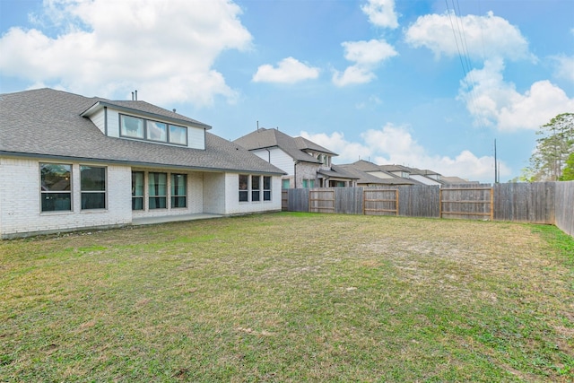 rear view of house with a yard