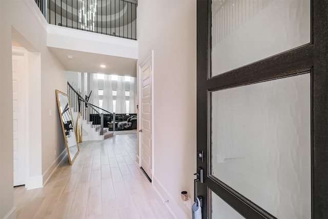 entryway featuring light hardwood / wood-style floors and a high ceiling