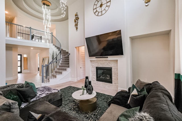 living room featuring a towering ceiling and a fireplace