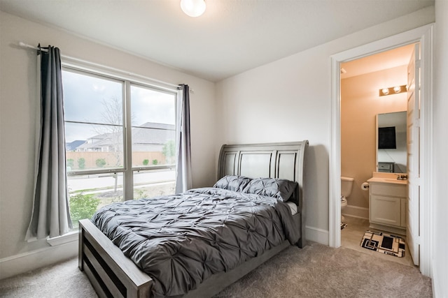 carpeted bedroom featuring ensuite bathroom