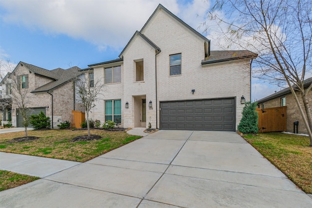 view of front of property with a garage and a front lawn