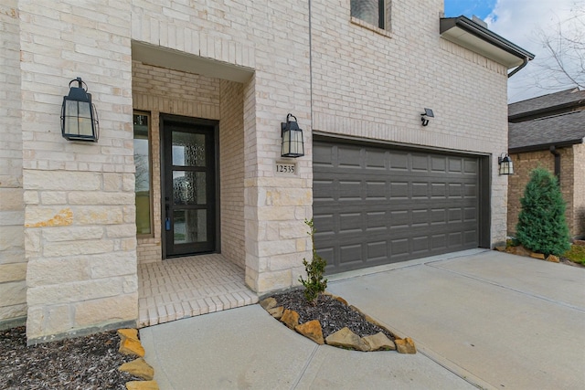 doorway to property with a garage