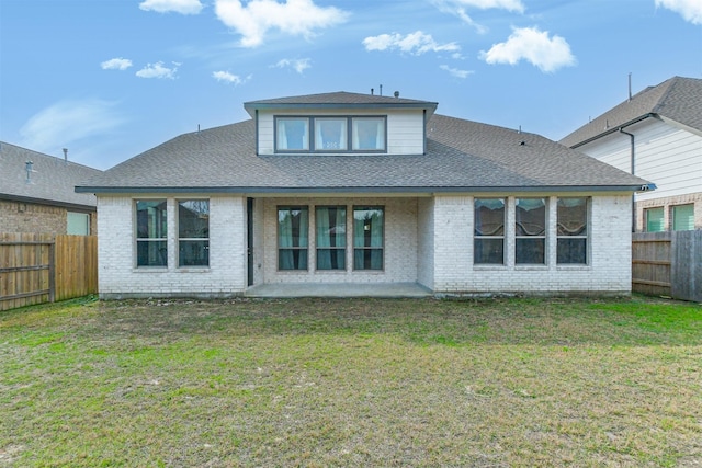 rear view of house with a patio area and a lawn