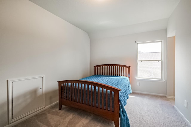 carpeted bedroom featuring vaulted ceiling