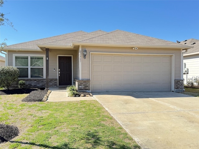 ranch-style house featuring a garage and a front lawn