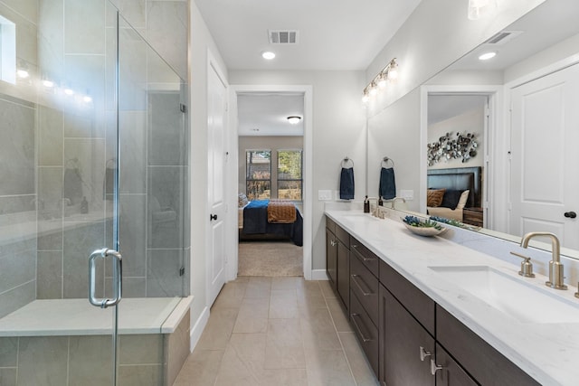 bathroom with vanity, tile patterned flooring, and a shower with door