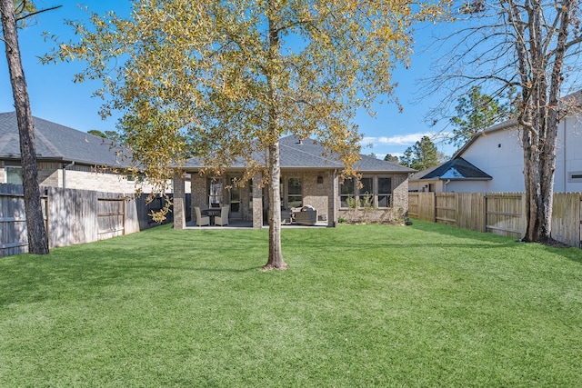 back of property with a patio and a lawn