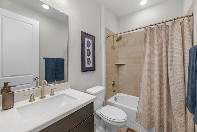 full bathroom with vanity, shower / tub combo with curtain, and toilet