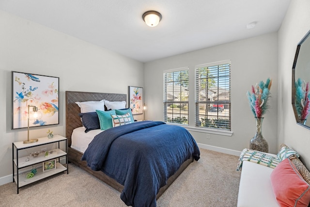 bedroom featuring light carpet