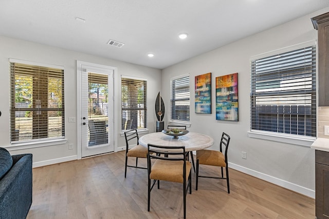 dining space featuring light wood-type flooring