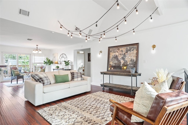 living room featuring lofted ceiling, dark hardwood / wood-style floors, a chandelier, and rail lighting