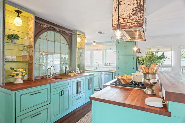 kitchen featuring sink, ornamental molding, wooden counters, and appliances with stainless steel finishes