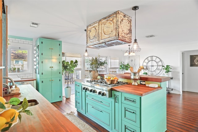 kitchen featuring green cabinets, stainless steel gas stovetop, dark hardwood / wood-style flooring, and butcher block countertops