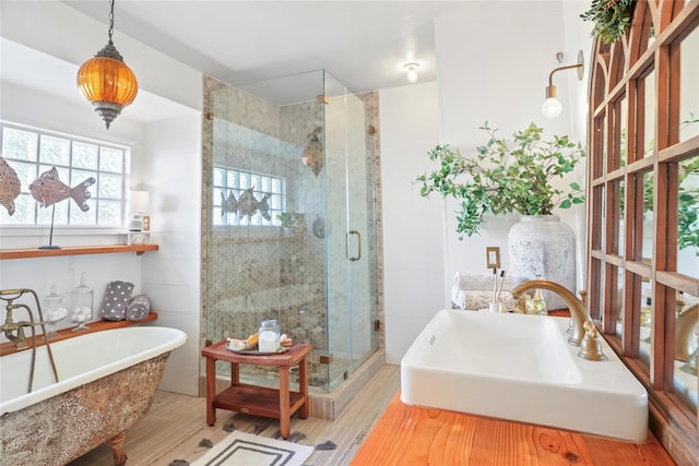 bathroom featuring separate shower and tub, sink, and hardwood / wood-style floors