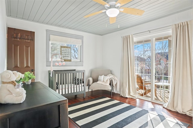 sitting room with ceiling fan, dark hardwood / wood-style floors, and wooden ceiling