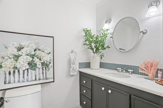 bathroom featuring vanity, ornamental molding, and toilet