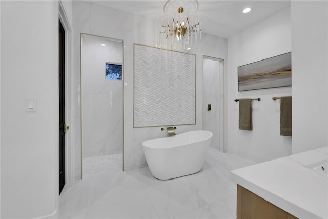 full bath with a walk in shower, recessed lighting, vanity, marble finish floor, and a soaking tub