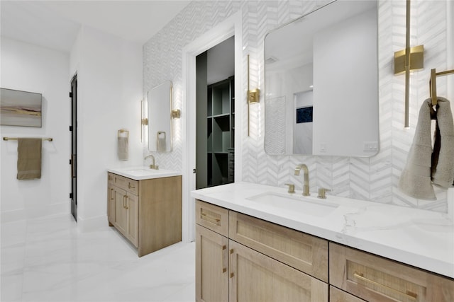 bathroom with tasteful backsplash, two vanities, and a sink