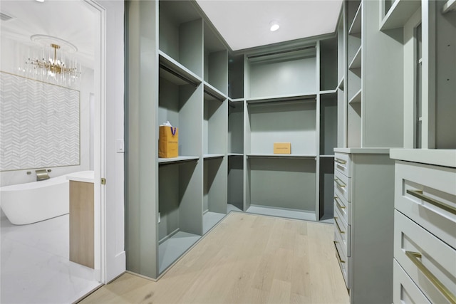 spacious closet with light wood-type flooring and visible vents