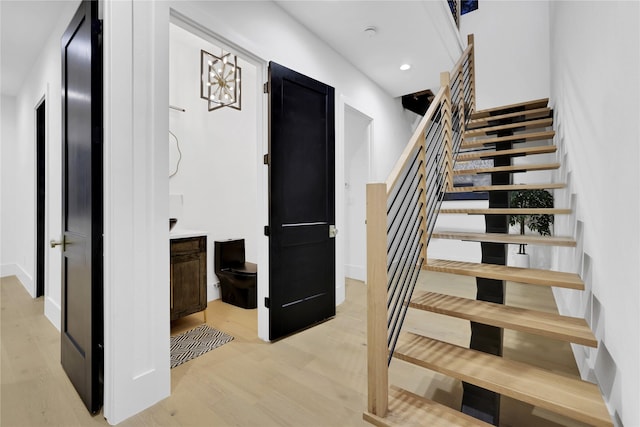 staircase featuring recessed lighting and wood finished floors