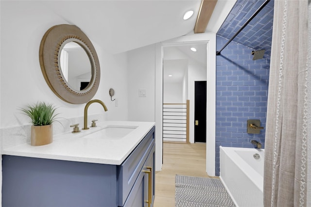 bathroom featuring shower / tub combo with curtain, vanity, and wood finished floors