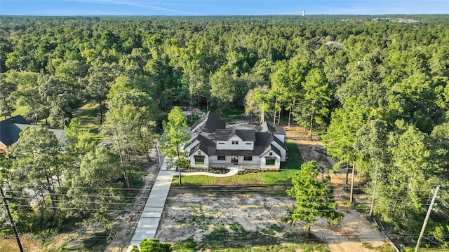 bird's eye view with a wooded view